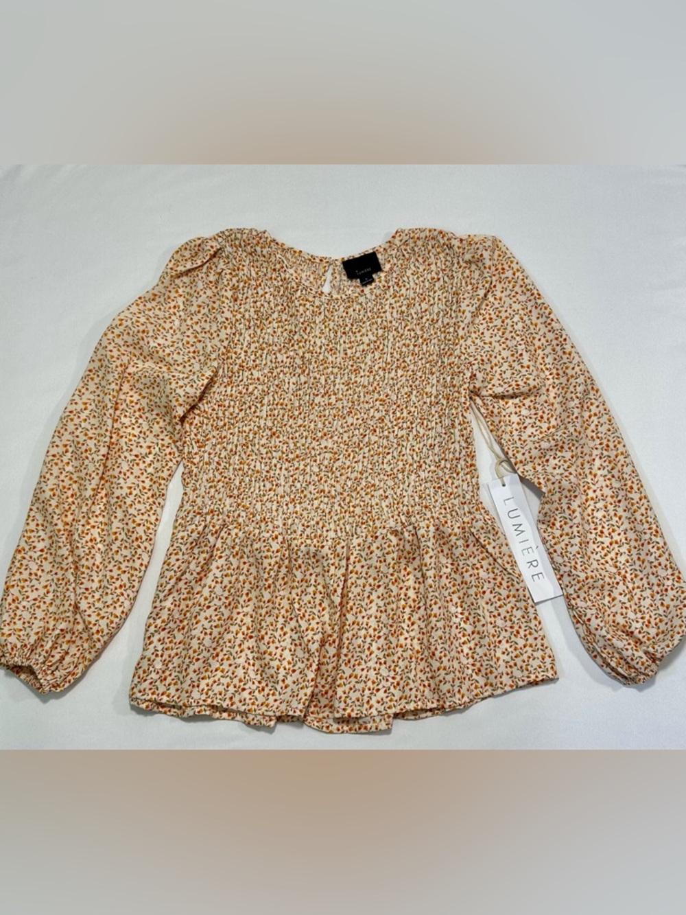Lumiere long sleeve feminine Floral Print Smocked Peplum Top. 
Size: Small - Picture 7 of 11